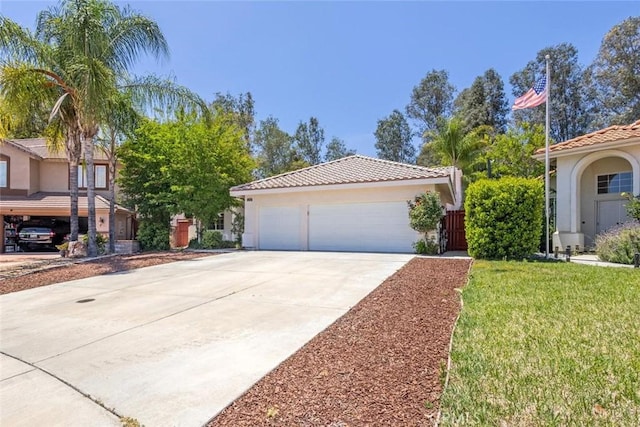 24563 Calle Perla, Murrieta, CA 92562 - view of front of home with stucco siding, a tile roof, concrete driveway, and a front lawn
