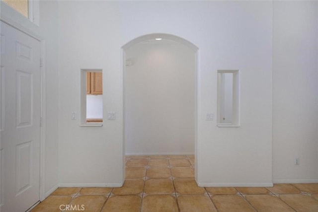 24563 Calle Perla, Murrieta, CA 92562 - hall featuring arched walkways, tile patterned flooring, and baseboards