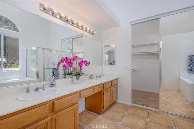 24563 Calle Perla, Murrieta, CA 92562 - full bathroom with double vanity, a garden tub, a stall shower, a spacious closet, and tile patterned floors