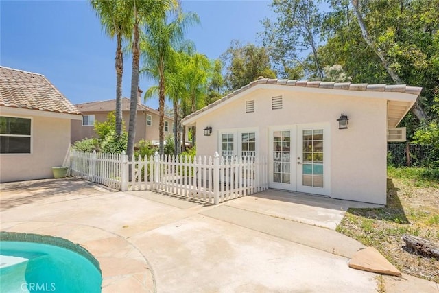 24563 Calle Perla, Murrieta, CA 92562 - back of property with french doors, stucco siding, a patio, and a tiled roof