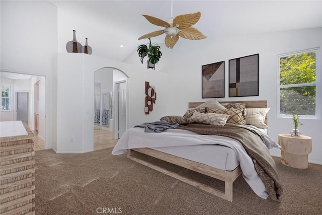 24563 Calle Perla, Murrieta, CA 92562 - carpeted bedroom with arched walkways, multiple windows, high vaulted ceiling, ensuite bathroom, and ceiling fan