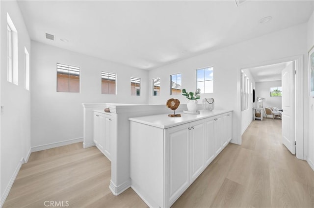 97 Twin Gables, Irvine, CA 92620 - corridor featuring light wood finished floors, plenty of natural light, and baseboards
