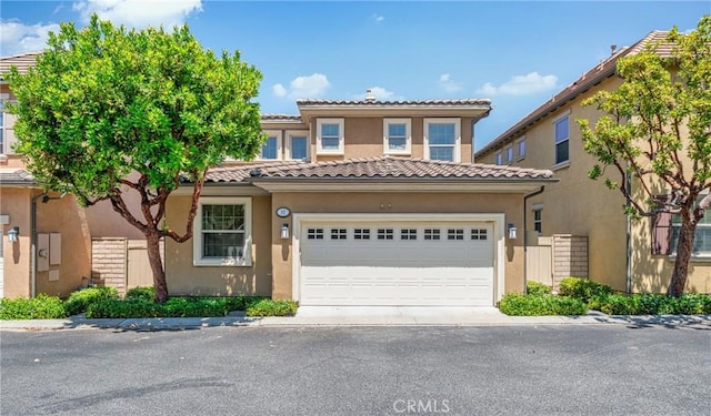 97 Twin Gables, Irvine, CA 92620 - mediterranean / spanish-style home featuring stucco siding, an attached garage, and a tile roof