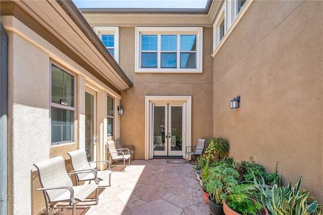 97 Twin Gables, Irvine, CA 92620 - doorway to property featuring french doors, a patio area, and stucco siding