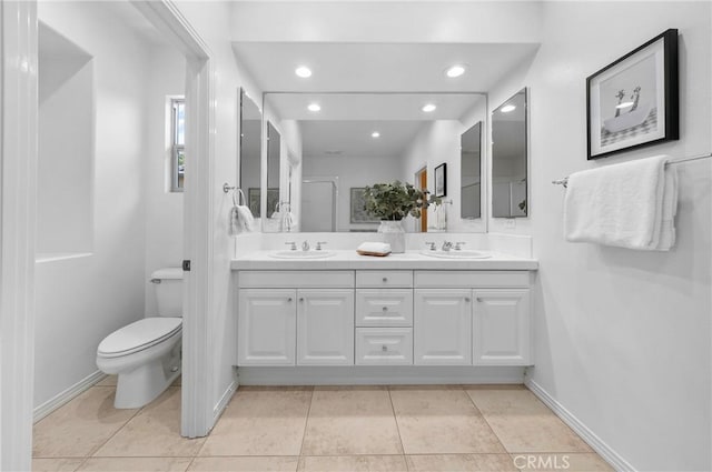 97 Twin Gables, Irvine, CA 92620 - bathroom with double vanity, toilet, tile patterned floors, recessed lighting, and baseboards