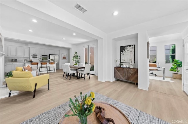97 Twin Gables, Irvine, CA 92620 - living room with recessed lighting, light wood-style floors, and baseboards