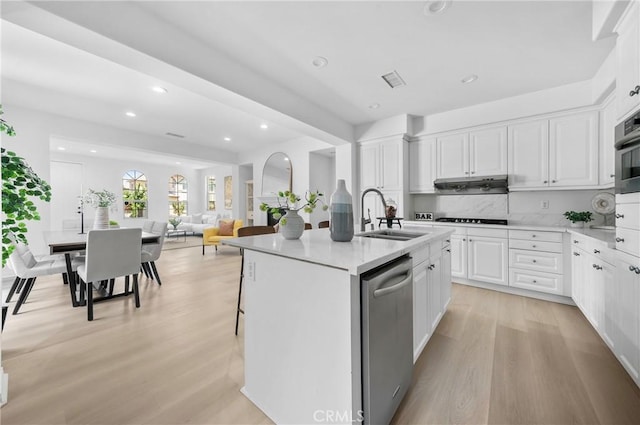 97 Twin Gables, Irvine, CA 92620 - kitchen with a sink, light wood finished floors, recessed lighting, an island with sink, and white cabinets