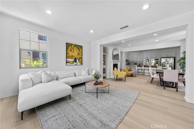 97 Twin Gables, Irvine, CA 92620 - living area featuring recessed lighting, light wood-style flooring, and baseboards
