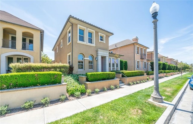 97 Twin Gables, Irvine, CA 92620 - mediterranean / spanish house featuring stucco siding, a balcony, and a residential view