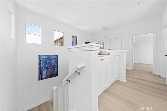 97 Twin Gables, Irvine, CA 92620 - corridor with an upstairs landing, light wood-type flooring, and baseboards