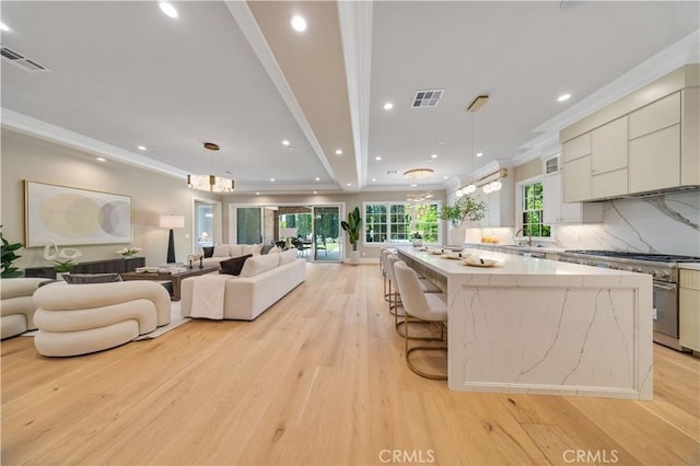 608 Arbolada Dr, Arcadia, CA 91006 - kitchen featuring stainless steel stove, open floor plan, a large island, light wood-type flooring, and ornamental molding