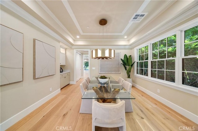 608 Arbolada Dr, Arcadia, CA 91006 - dining area with a tray ceiling, healthy amount of natural light, light wood-style floors, crown molding, and baseboards
