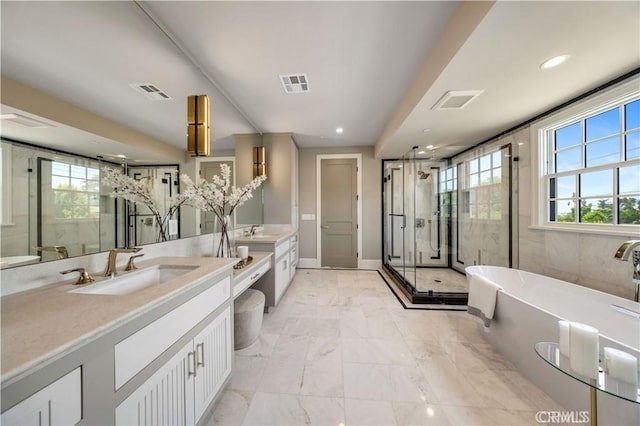 608 Arbolada Dr, Arcadia, CA 91006 - full bathroom with two vanities, a shower stall, a freestanding tub, marble finish flooring, and recessed lighting