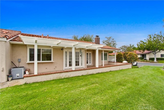 28161 Via Chabas, Mission Viejo, CA 92692 - back of property with a chimney, a pergola, a yard, stucco siding, and a tiled roof