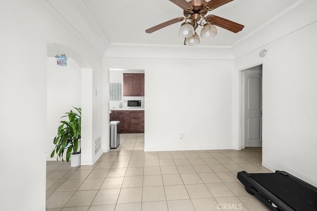 2946 Missouri Ave, South Gate, CA 90280 - empty room featuring crown molding, ceiling fan, light tile patterned floors, a smoke detector, and arched walkways