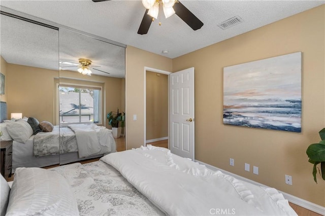 23801 Birch Ln, Mission Viejo, CA 92691 - bedroom with a textured ceiling, baseboards, and a ceiling fan