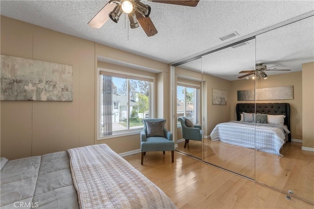 23801 Birch Ln, Mission Viejo, CA 92691 - bedroom featuring a textured ceiling, wood finished floors, baseboards, and a ceiling fan