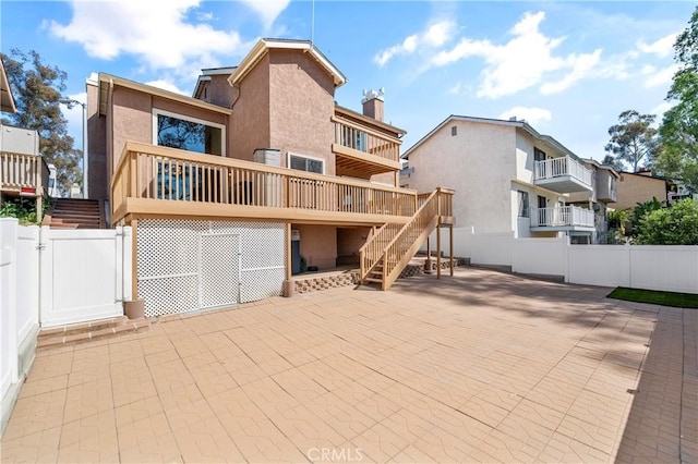 23801 Birch Ln, Mission Viejo, CA 92691 - rear view of house featuring stairs, a gate, a patio, stucco siding, and a chimney