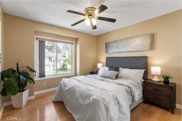 23801 Birch Ln, Mission Viejo, CA 92691 - bedroom featuring light wood-style floors, baseboards, ceiling fan, and a textured ceiling