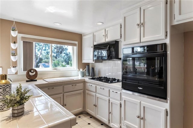 23801 Birch Ln, Mission Viejo, CA 92691 - kitchen with tile counters, black appliances, decorative backsplash, white cabinetry, and recessed lighting