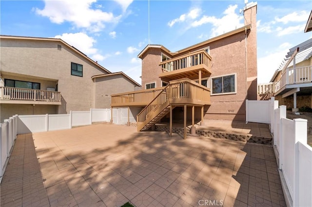 23801 Birch Ln, Mission Viejo, CA 92691 - rear view of house with stairway, stucco siding, a fenced backyard, a wooden deck, and a patio area