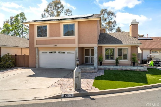 23801 Birch Ln, Mission Viejo, CA 92691 - view of front of home with driveway, a garage, roof mounted solar panels, and stucco siding