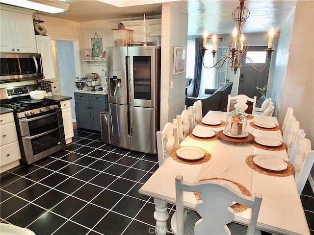 251 W Markland Dr, Monterey Park, CA 91754 - kitchen featuring appliances with stainless steel finishes, a chandelier, dark tile patterned floors, dark countertops, and white cabinets