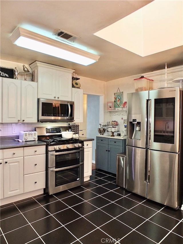251 W Markland Dr, Monterey Park, CA 91754 - kitchen with appliances with stainless steel finishes, white cabinetry, dark countertops, and dark tile patterned floors