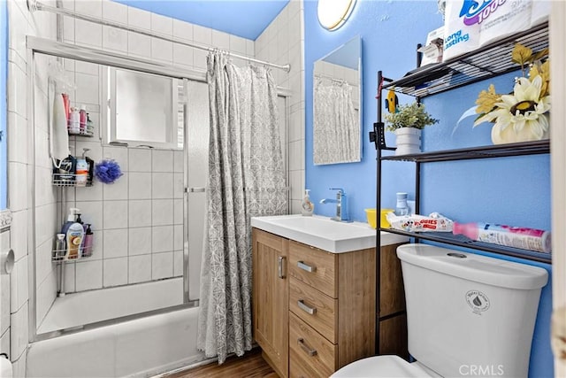 4776 E Lowe Ave, Fresno, CA 93702 - full bathroom with shower / tub combo with curtain, vanity, toilet, and wood finished floors
