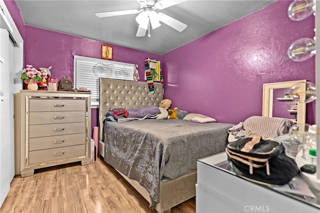 4776 E Lowe Ave, Fresno, CA 93702 - bedroom featuring wood finished floors, a textured wall, and a ceiling fan