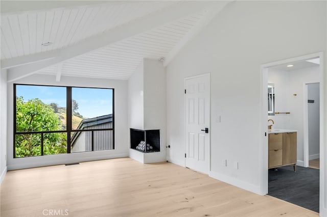 1450 Terrace Way, Laguna Beach, CA 92651 - unfurnished living room with wood finished floors, beam ceiling, high vaulted ceiling, and a multi sided fireplace