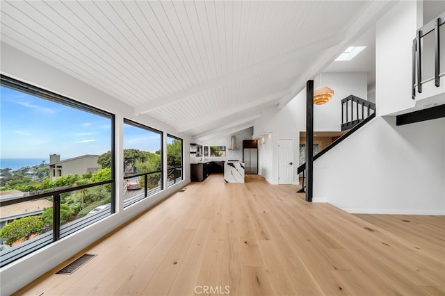 1450 Terrace Way, Laguna Beach, CA 92651 - unfurnished living room with light wood-style floors, stairs, a skylight, and baseboards