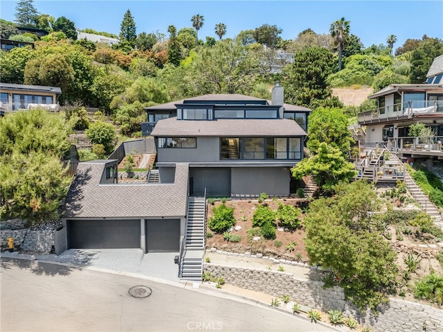 1450 Terrace Way, Laguna Beach, CA 92651 - view of front of property with stairs, a balcony, an attached garage, and a chimney