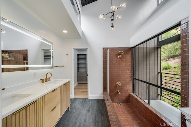1450 Terrace Way, Laguna Beach, CA 92651 - bathroom featuring double vanity, tiled shower, wood finished floors, baseboards, and a towering ceiling