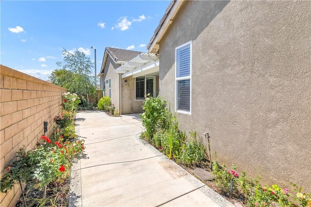 243 Firestone, Hemet, CA 92545 - view of property exterior with stucco siding, a fenced backyard, a patio, and a pergola