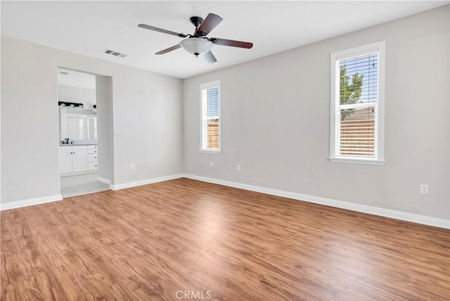 243 Firestone, Hemet, CA 92545 - empty room featuring plenty of natural light, light wood-style flooring, baseboards, and ceiling fan