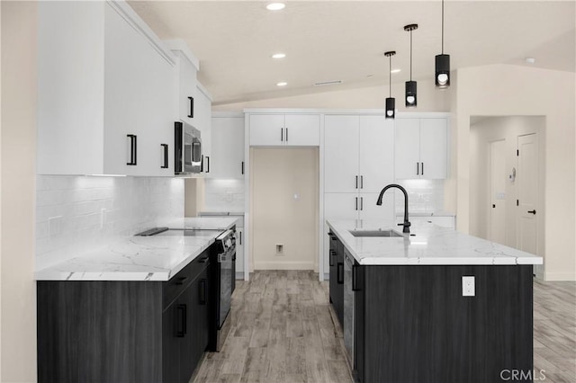 9641 Buena Vista St, Apple Valley, CA 92308 - kitchen featuring stainless steel microwave, electric range, white cabinetry, light wood-style flooring, and lofted ceiling
