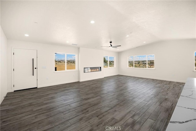 9641 Buena Vista St, Apple Valley, CA 92308 - unfurnished living room featuring dark wood-type flooring, recessed lighting, a ceiling fan, vaulted ceiling, and a glass covered fireplace