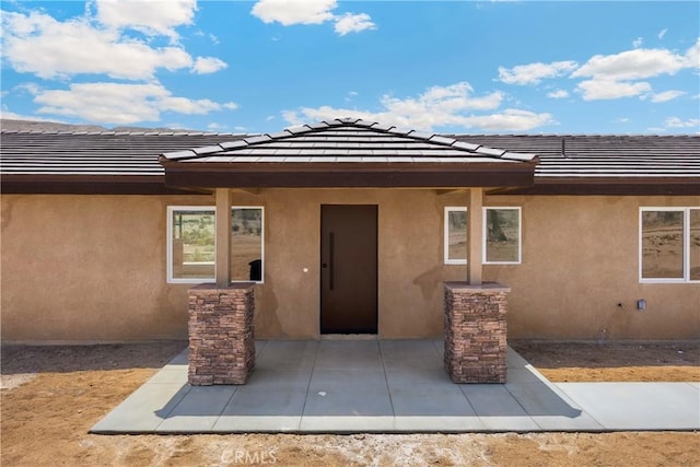 9641 Buena Vista St, Apple Valley, CA 92308 - doorway to property with stucco siding, a patio, and a tile roof