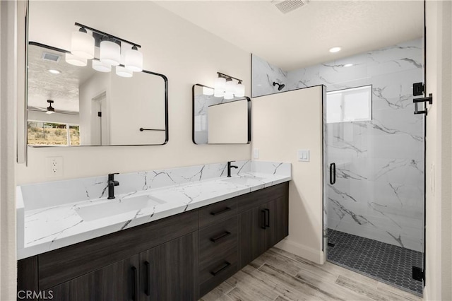 9641 Buena Vista St, Apple Valley, CA 92308 - full bathroom with a marble finish shower, double vanity, ceiling fan, and wood finished floors
