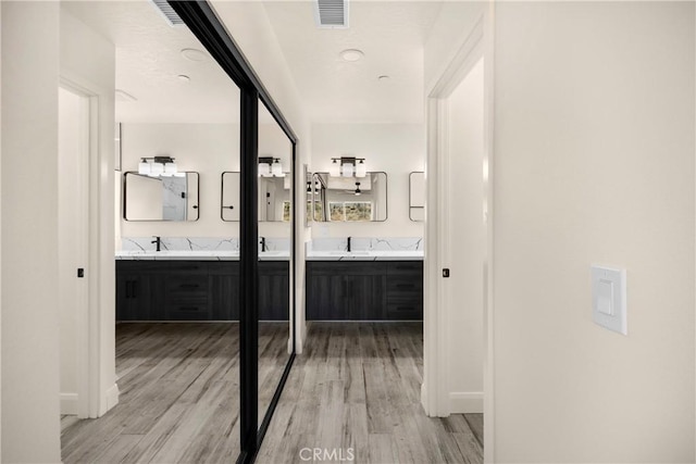 9641 Buena Vista St, Apple Valley, CA 92308 - full bathroom with double vanity and wood finished floors