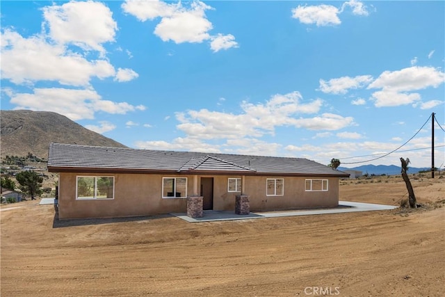 9641 Buena Vista St, Apple Valley, CA 92308 - view of front facade with a mountain view, a tile roof, a patio, and stucco siding