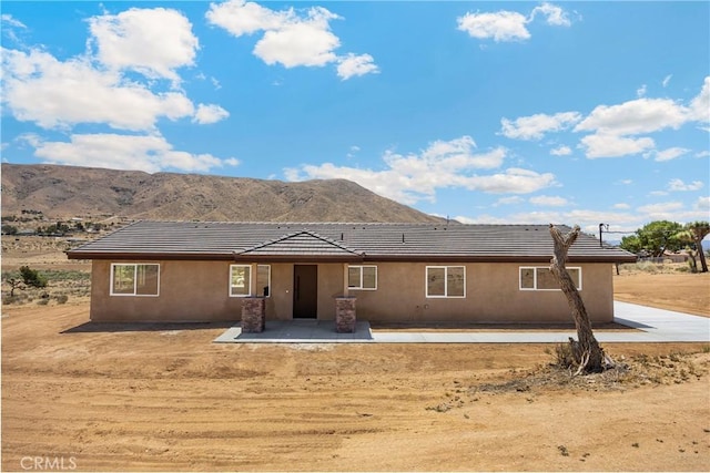 9641 Buena Vista St, Apple Valley, CA 92308 - rear view of property with a mountain view, a tile roof, and stucco siding