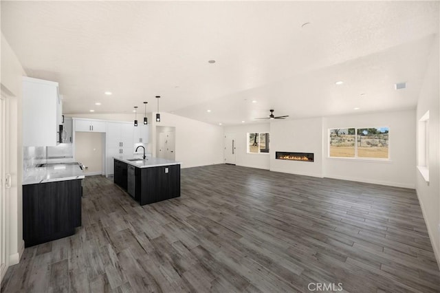 9641 Buena Vista St, Apple Valley, CA 92308 - unfurnished living room with wood finished floors, a ceiling fan, a glass covered fireplace, recessed lighting, and vaulted ceiling