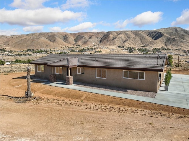 9641 Buena Vista St, Apple Valley, CA 92308 - view of front facade featuring a mountain view, a tiled roof, and stucco siding