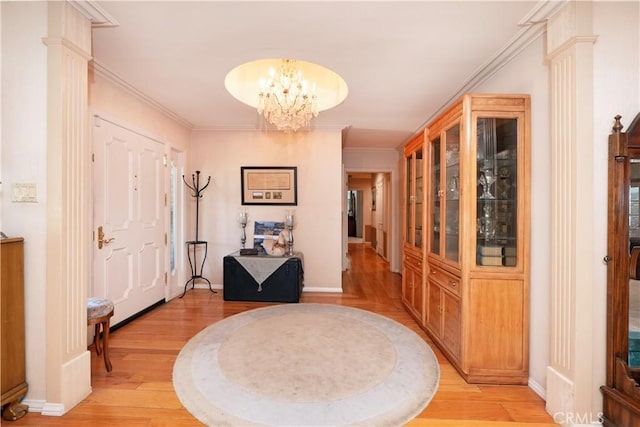3152 Parkside Dr, San Bernardino, CA 92404 - foyer with light wood-style flooring, a chandelier, baseboards, and ornamental molding