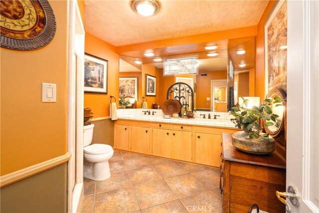 3152 Parkside Dr, San Bernardino, CA 92404 - full bath with double vanity, toilet, and tile patterned floors
