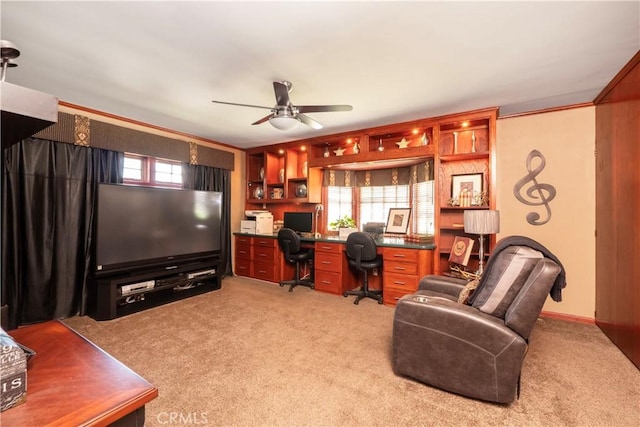 3152 Parkside Dr, San Bernardino, CA 92404 - home office with light colored carpet, a ceiling fan, and built in desk