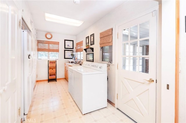 3152 Parkside Dr, San Bernardino, CA 92404 - laundry room featuring cabinet space, light flooring, washer and clothes dryer, and baseboards
