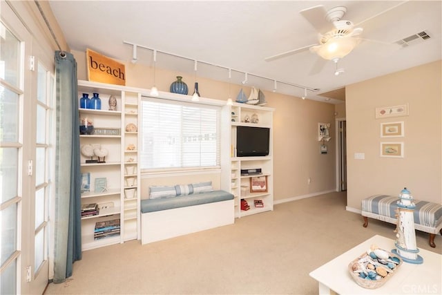 3152 Parkside Dr, San Bernardino, CA 92404 - living room featuring rail lighting, carpet, a ceiling fan, and baseboards